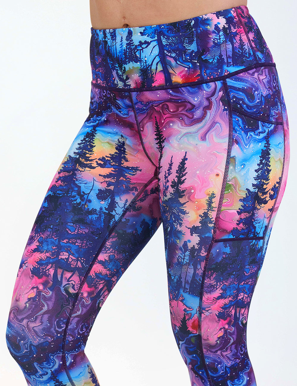 front of the watercolor rainbow patterned forest leggings against a white background