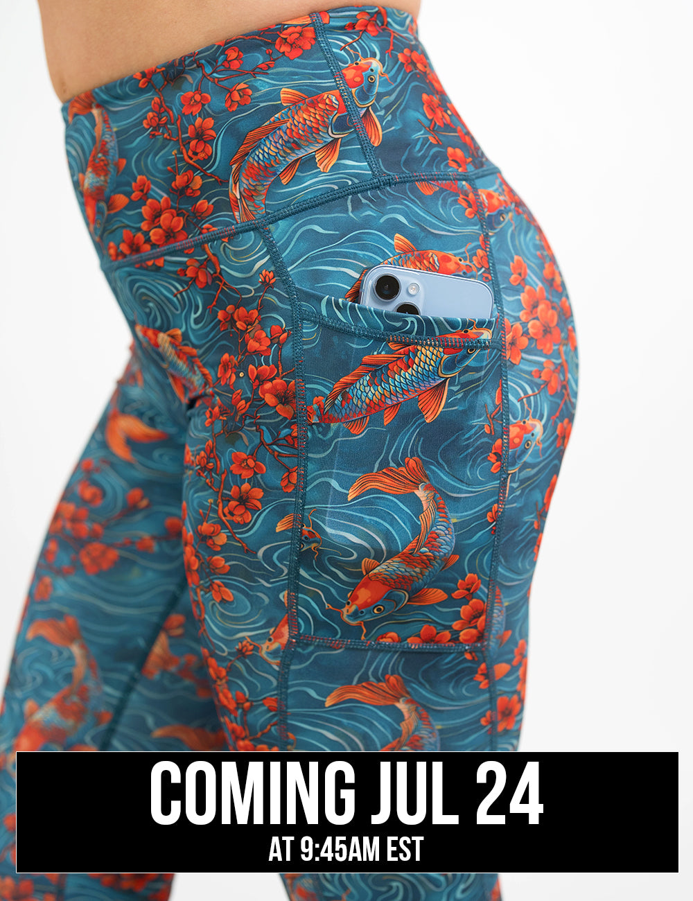 close up of the koi fish swimming with orange flowers leggings with a phone in its pocket, coming july 24