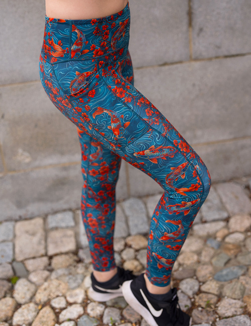 model wearing the full length koi fish swimming with orange flowers leggings