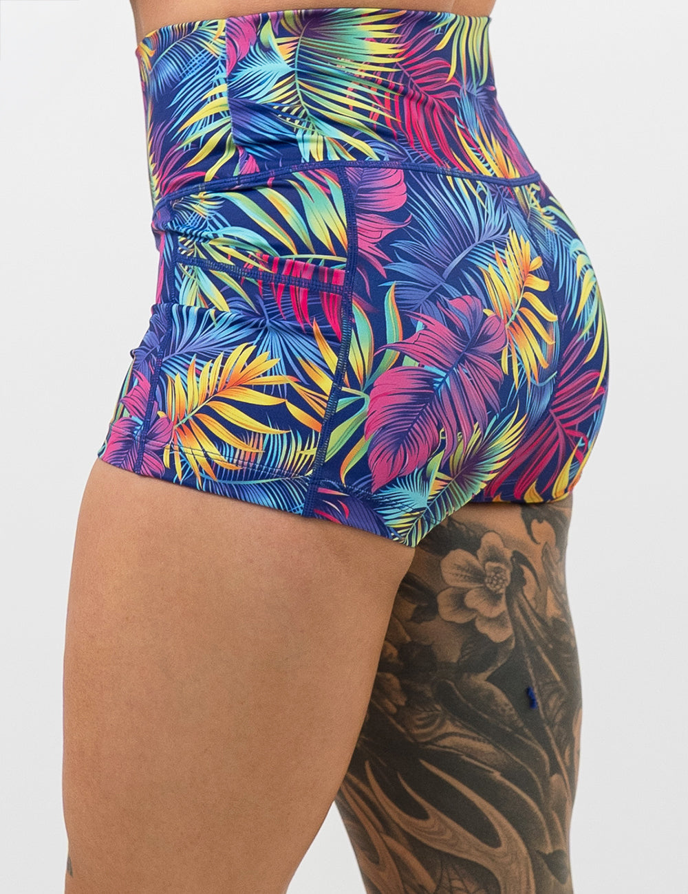 back of the 2.5 inch vibrant tropical leaves shorts against a white background