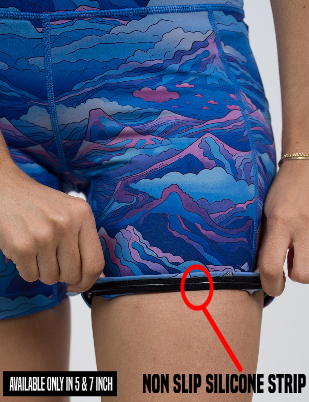 close up of the blue and pink mountains shorts being rolled up to show the non slip silicone strip found in the 5 and 7 inch shorts