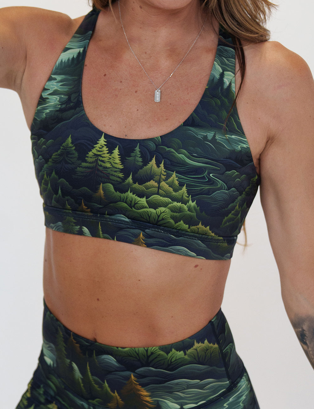 front of the tree patterned sports bra against a white background