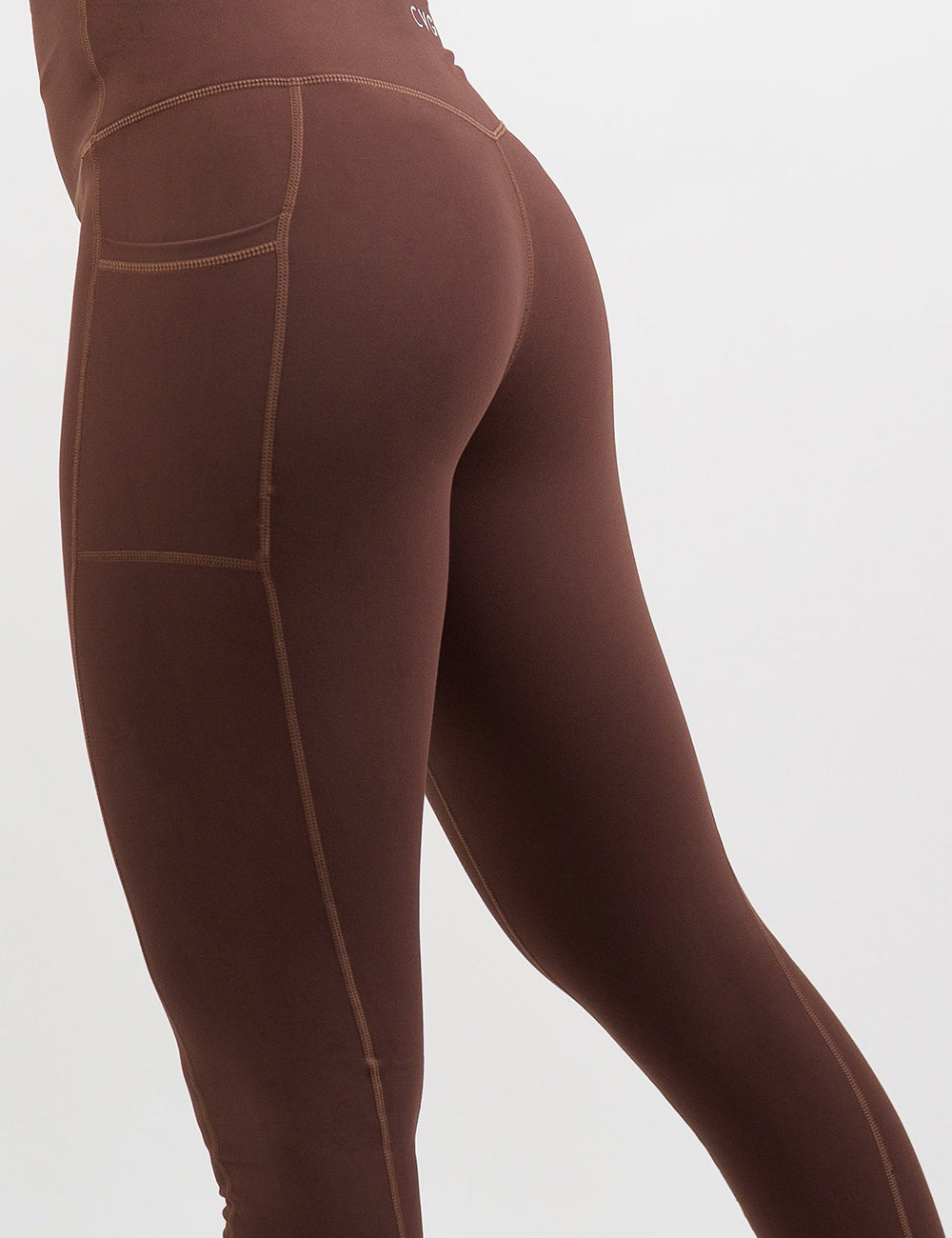 back of the solid light brown leggings against a white background