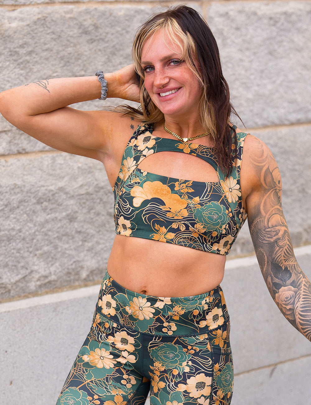 model wearing the gold and green flowers with gold accents vista bra