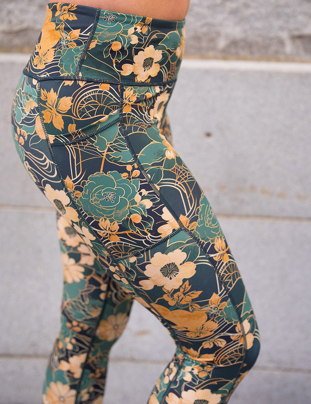 close up of the gold and green flowers with gold accents pattern leggings