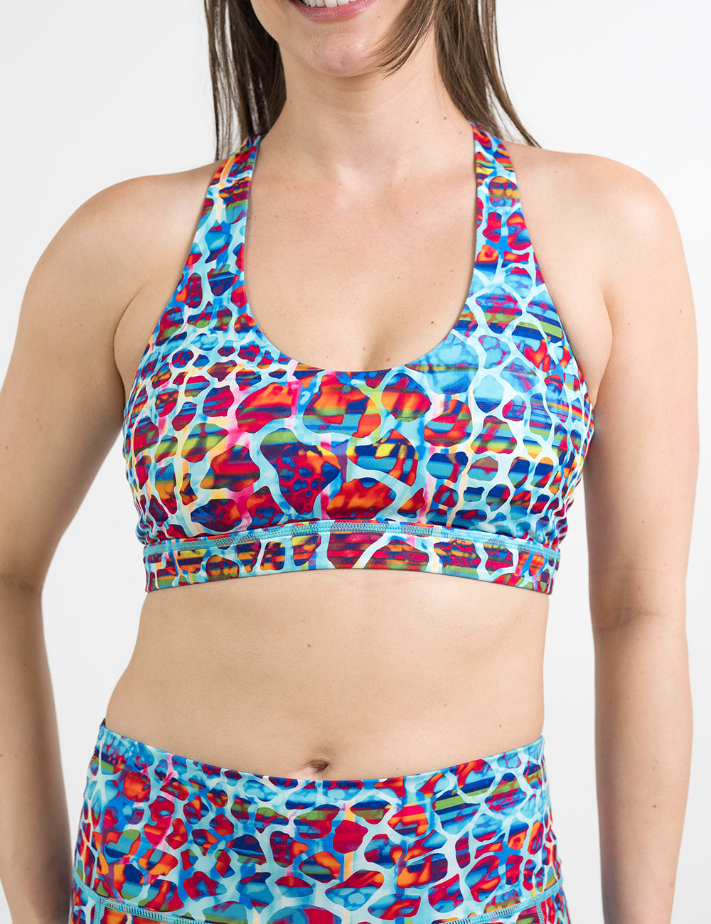 front of the yellow, blue, and red mosaic style butterfly back bra against a white background
