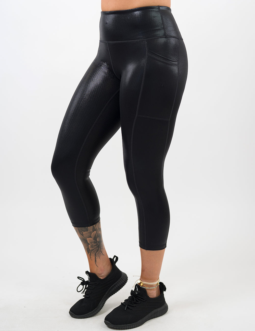 front of the capri black leather leggings against a white background