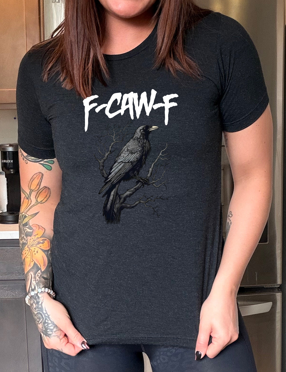 Black colored shirt with crow on branch graphic on it that says "F-CAW-F"