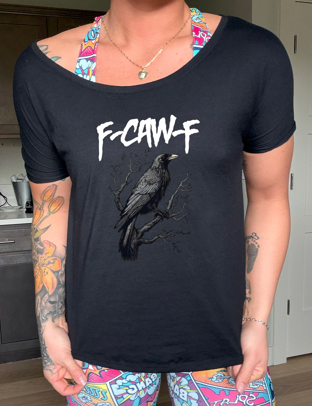 black slouchy tee with crow on branch graphic on it that says "F-CAW-F"