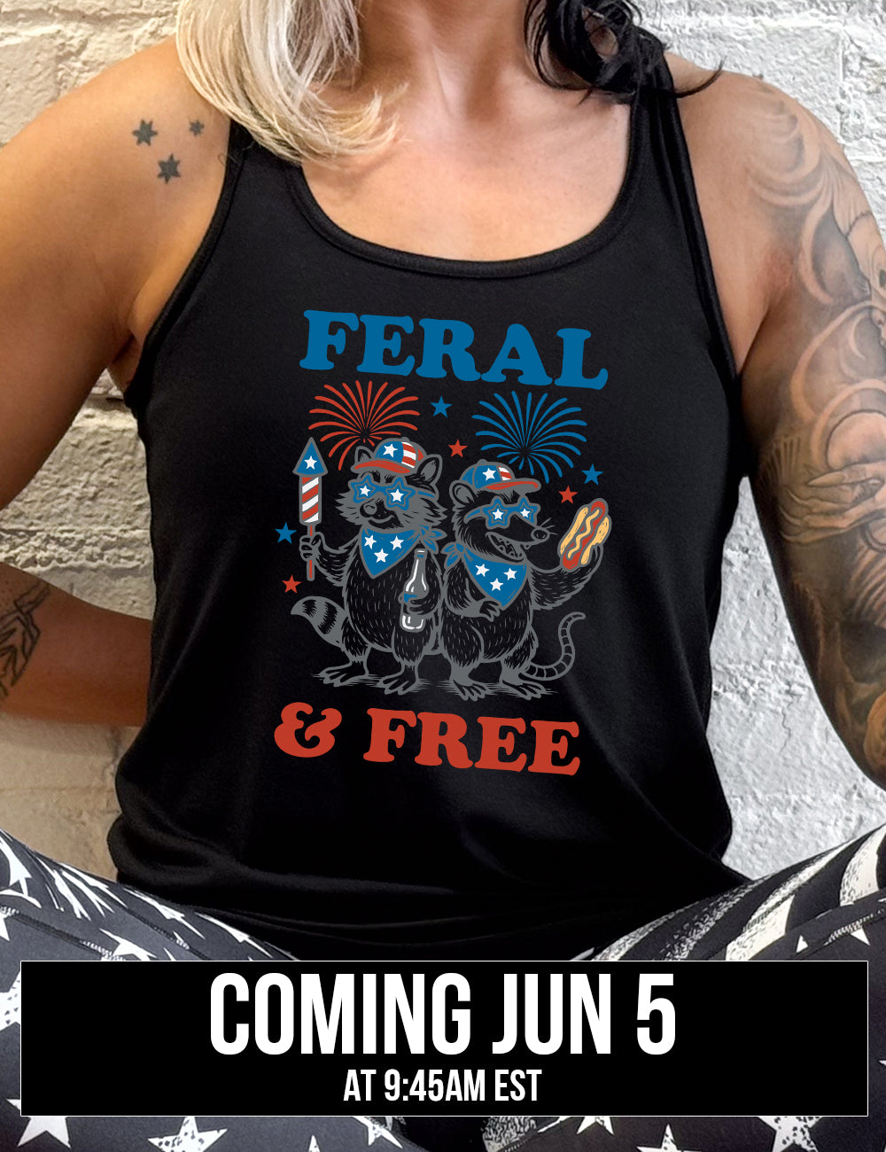 black flowy racerback tank with the words "feral & free" around the graphic of two racoons, both wearing American flag hats, sunglasses, and bandanas, one holding a firework and a beer bottle, the other holing a hotdogs, and fireworks going off above, and a few little stars, coming june 5th