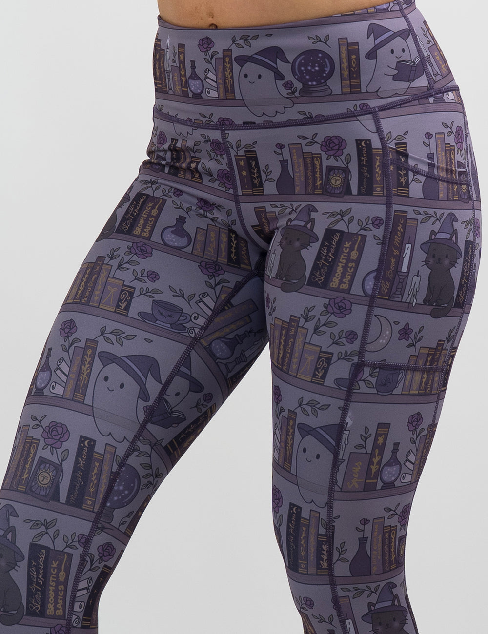 front of the ghosts and cats book shelves leggings against a white background