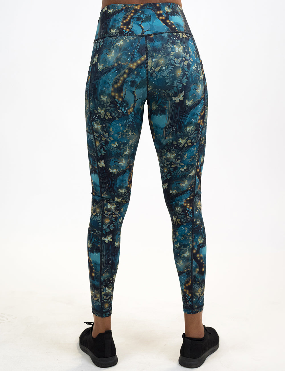 back of the forest filled with firefly's pattern leggings against a white background