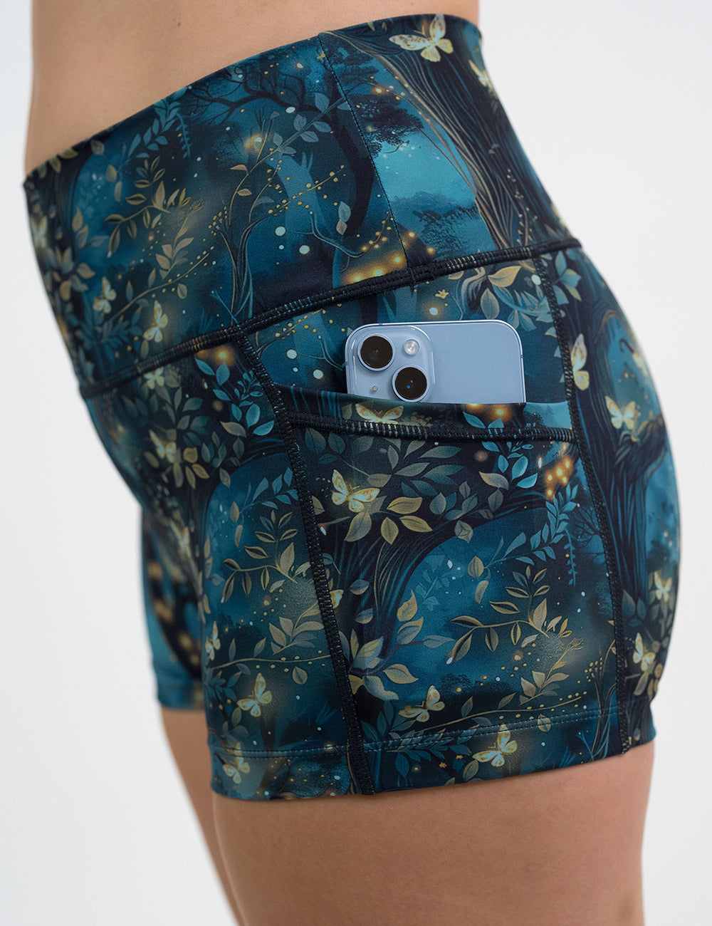 close up of the 2.5 inch forest filled with firefly's pattern shorts with a phone in its pocket
