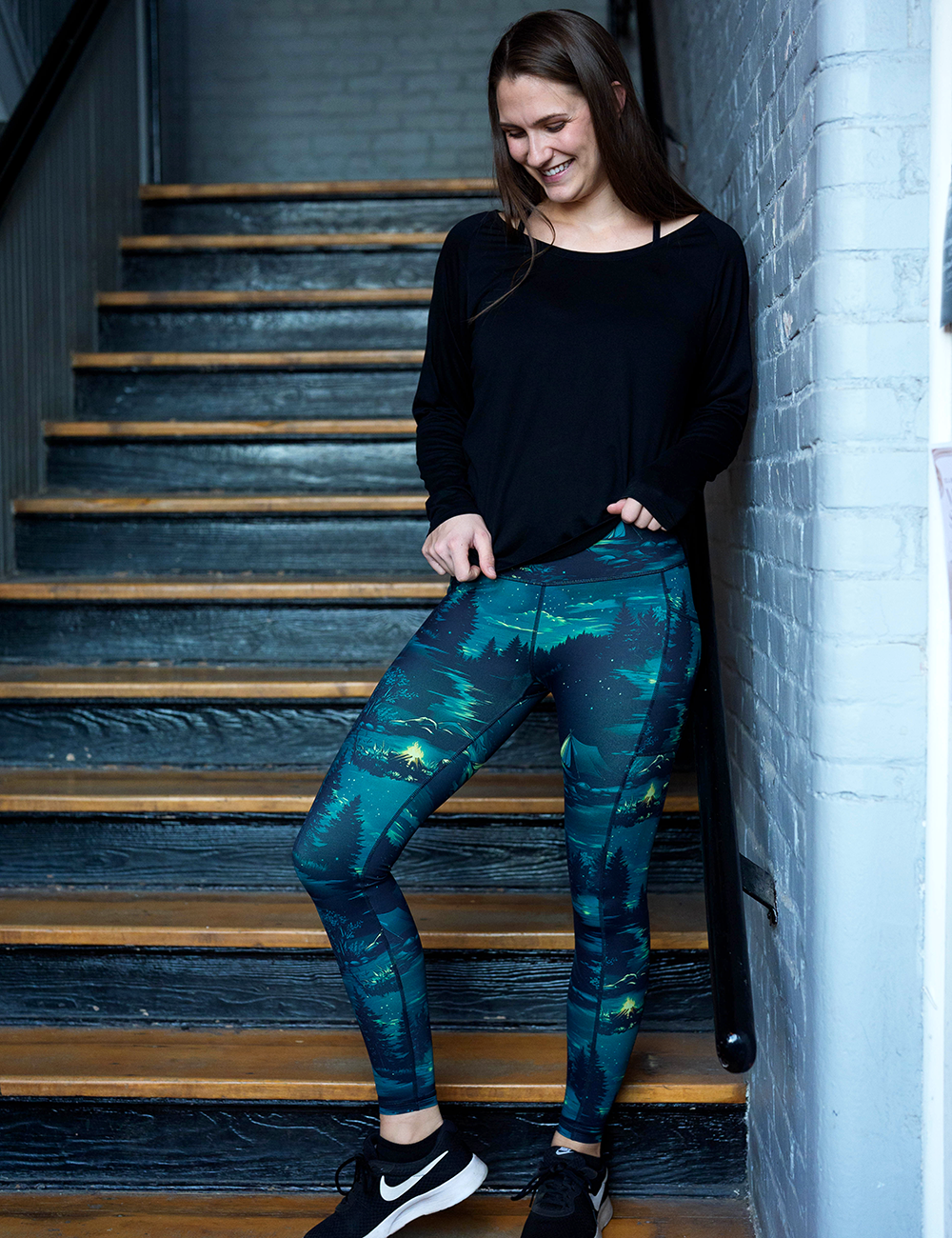model wearing the night time camp out full length leggings in a stairwell