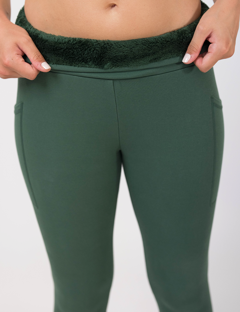 photo showing close up of green fleece lined inside material of green solid colored leggings