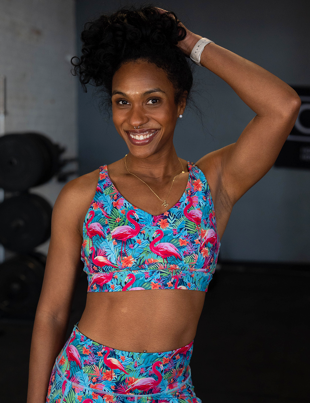 model wearing the colorful flamingos vitality bra in the gym