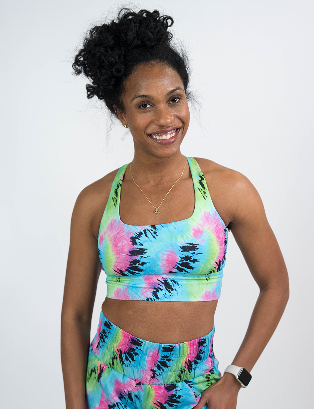 model wearing the colorful tie dye longline bra against a white background