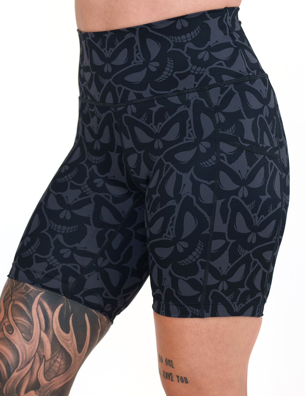 front of the 7 inch grey and black butterfly shaped skulls patterned shorts against a white background