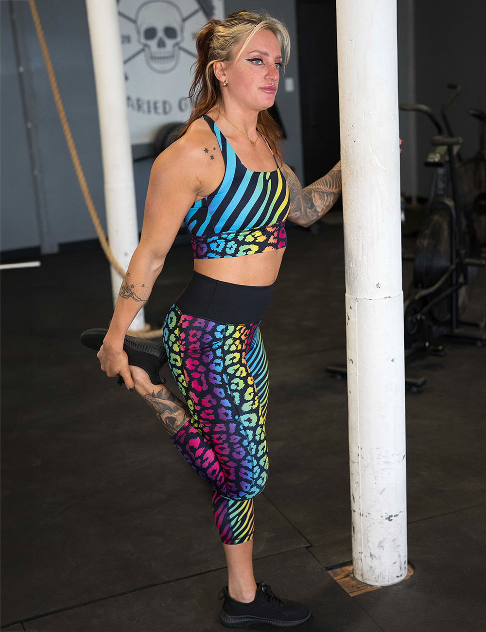model wearing the rainbow zebra and leopard print capri leggings in the gym
