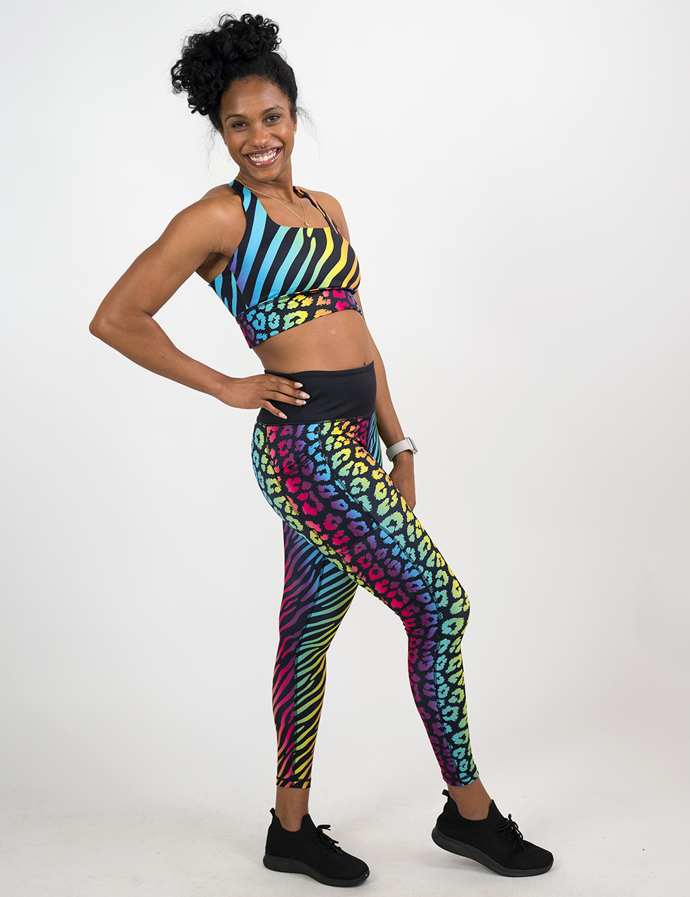 model wearing the full length rainbow leopard and zebra print leggings against a white background