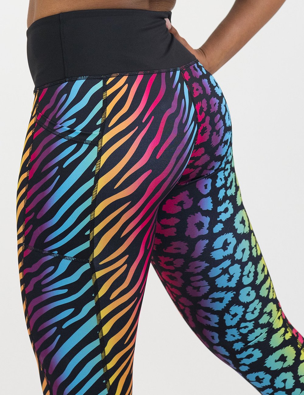 close up of the back of the zebra and leopard print rainbow leggings against a white background