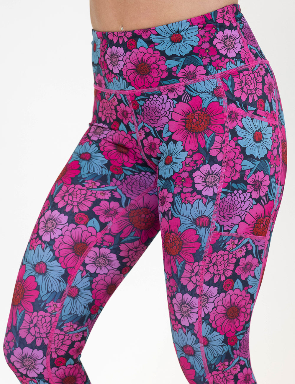 front of the pink and blue floral patterned leggings against a white background
