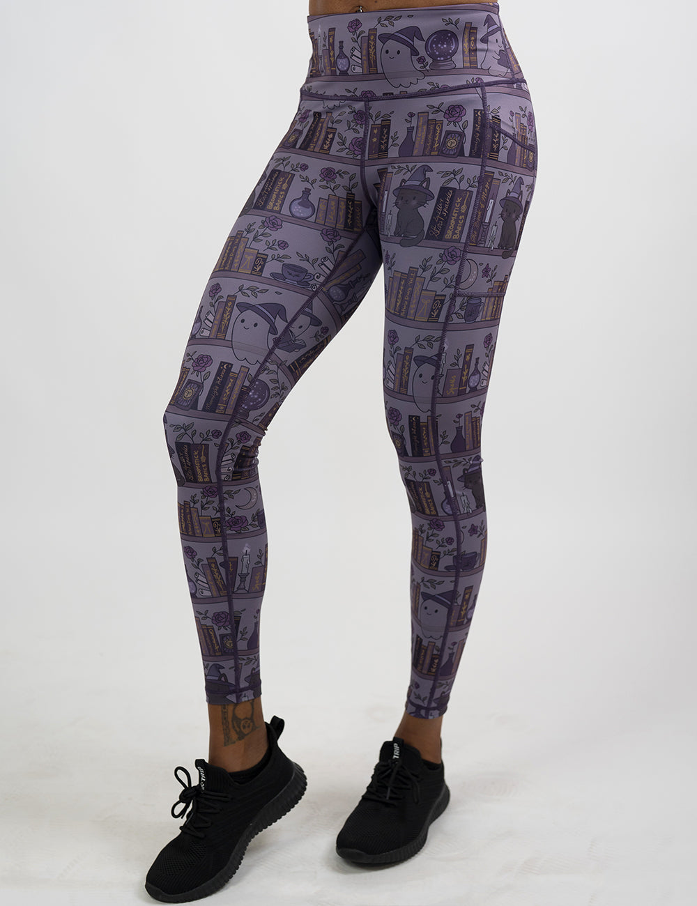 front of the ghosts and cats book shelves full length leggings against a white background