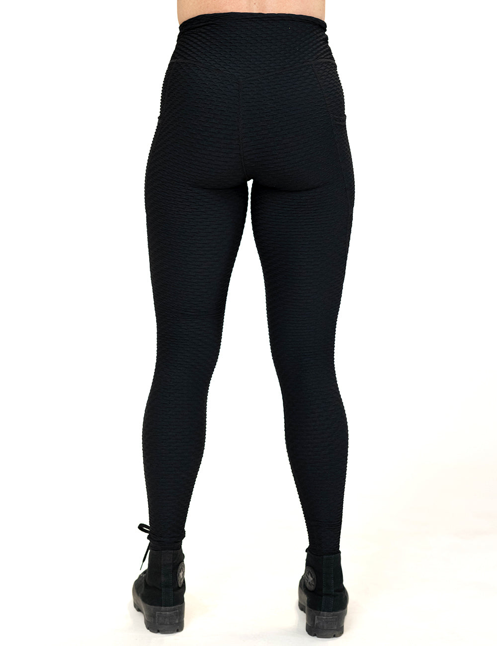 back of the full length black waffled texture leggings against a white background