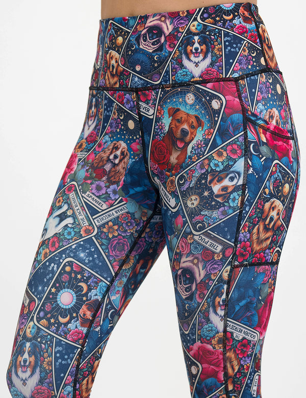 Colorful leggings with dog illustration pattern on it against a white background