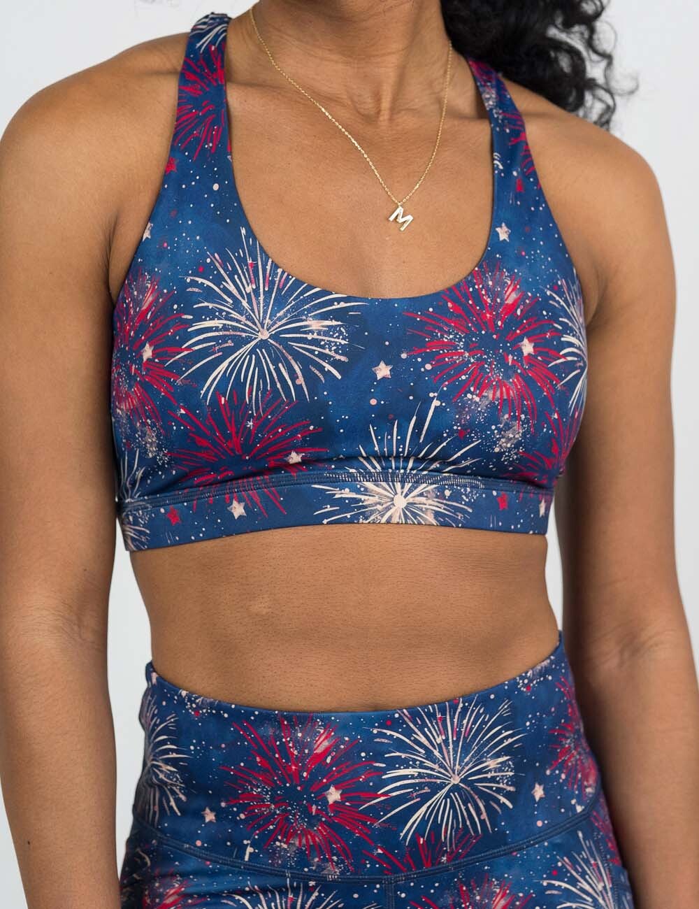 front of the red and white fireworks against a blue background butterfly back bra against a white background