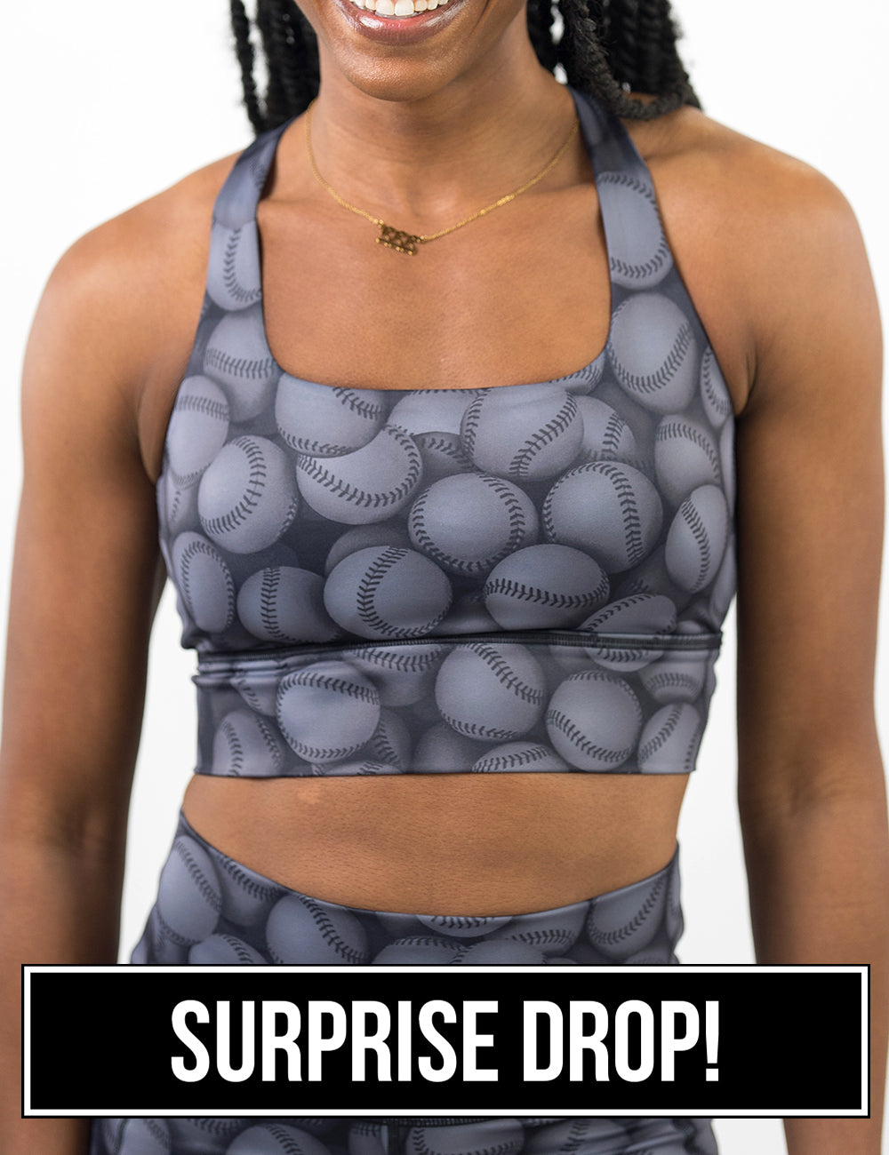 front of the dark grey baseball themed longline bra against a white background, surprise drop