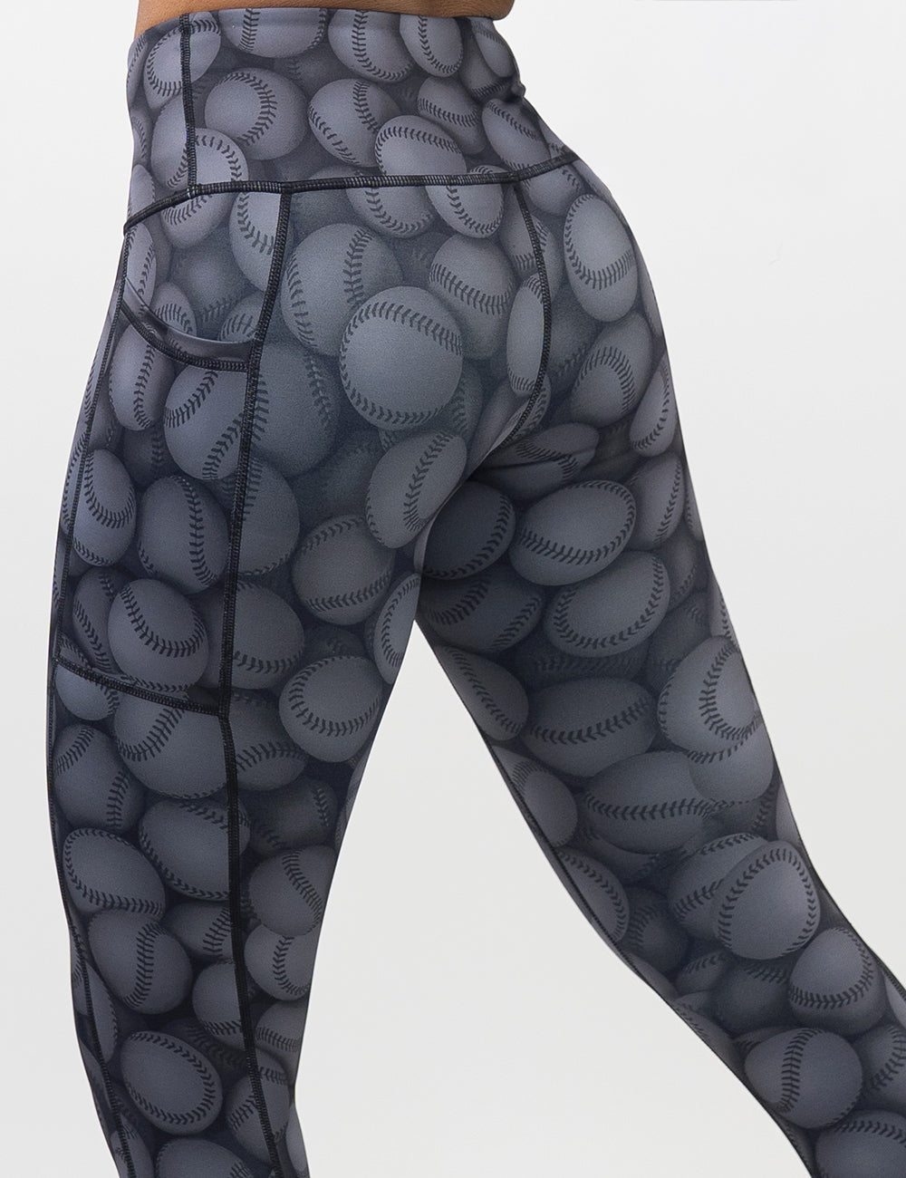 back of the dark grey baseball patterned leggings against a white background
