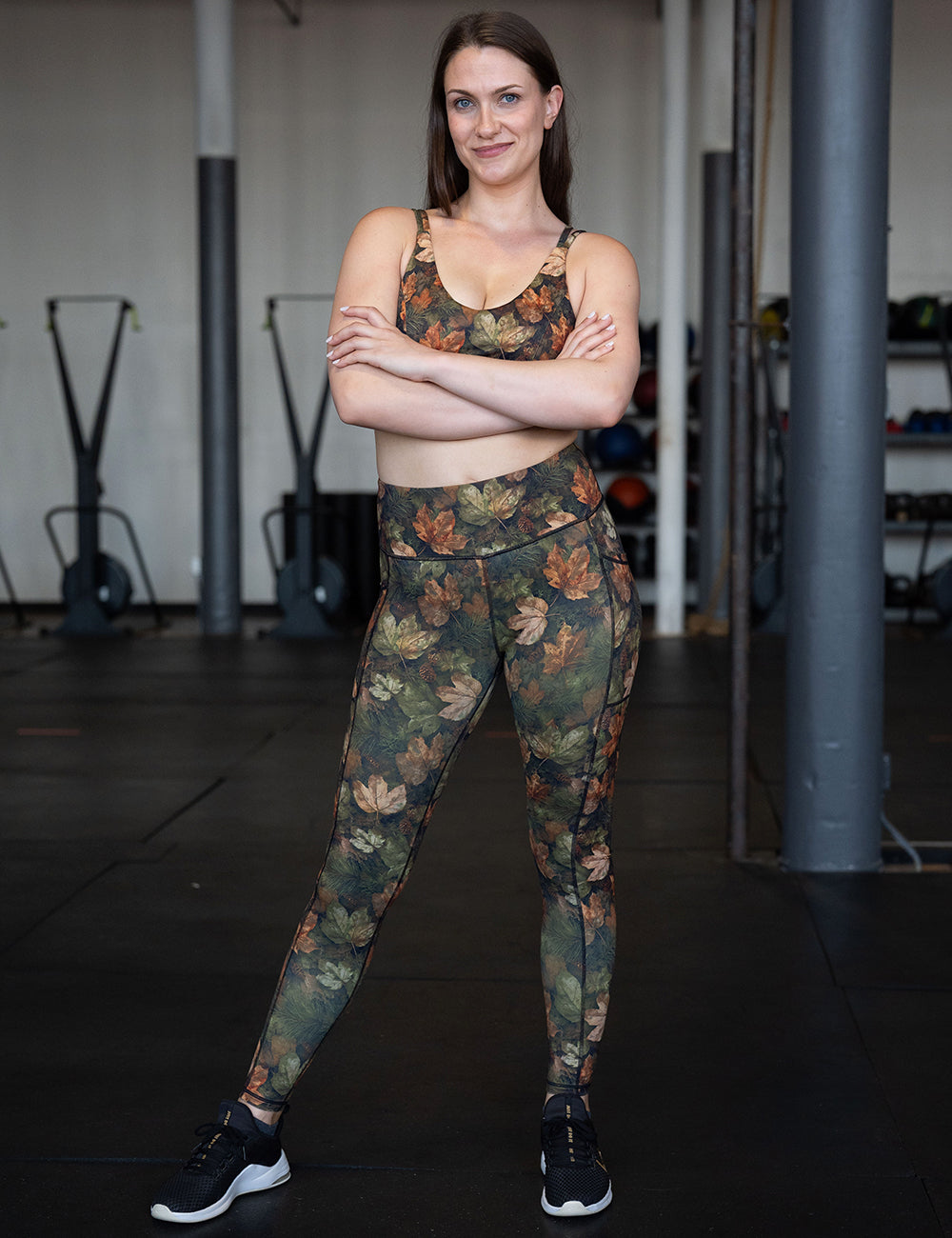 model wearing the forest floor covered in leaves full length leggings and bra in the gym