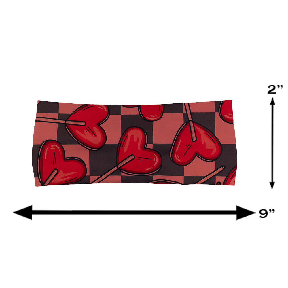 measurements of the heart lollypops on a checker board pattern headband, measurements show a height of 2 inches and a width of 9 inches
