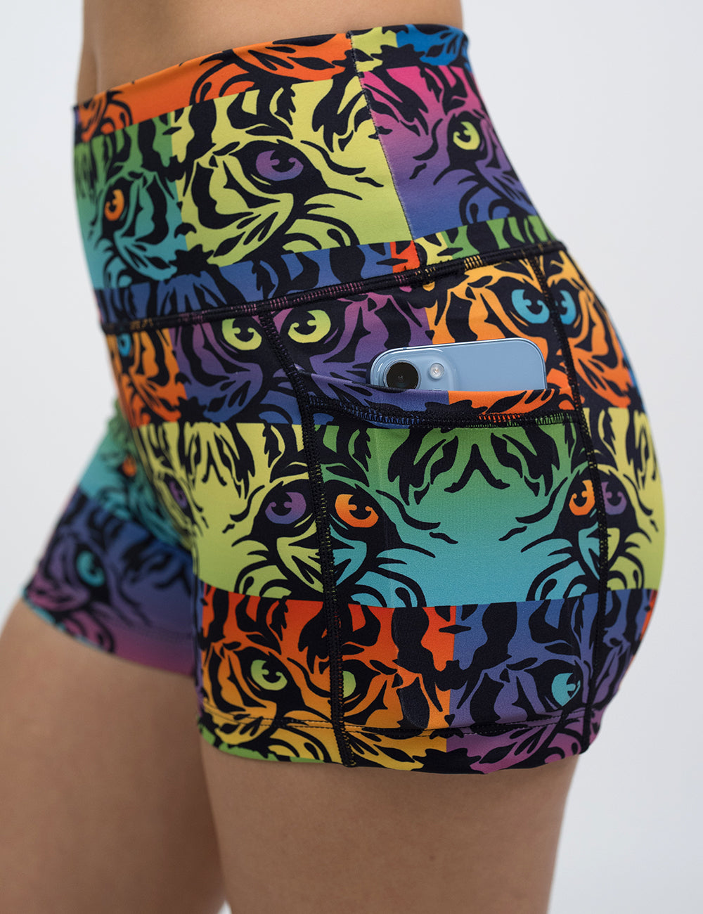 close up of the rainbow tiger print 2.5 inch shorts with a phone in the pocket