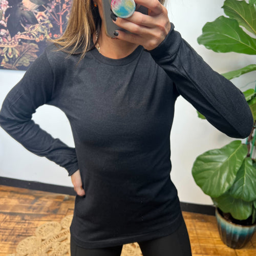 model wearing a black long sleeve shirt