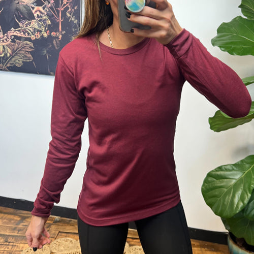 model wearing a maroon long sleeve shirt