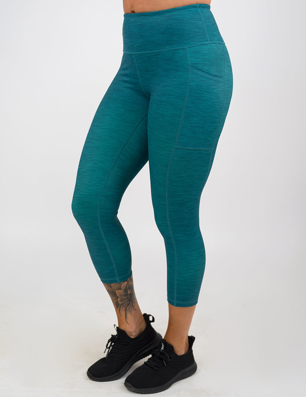 front of the capri teal heather pattern leggings against a white background