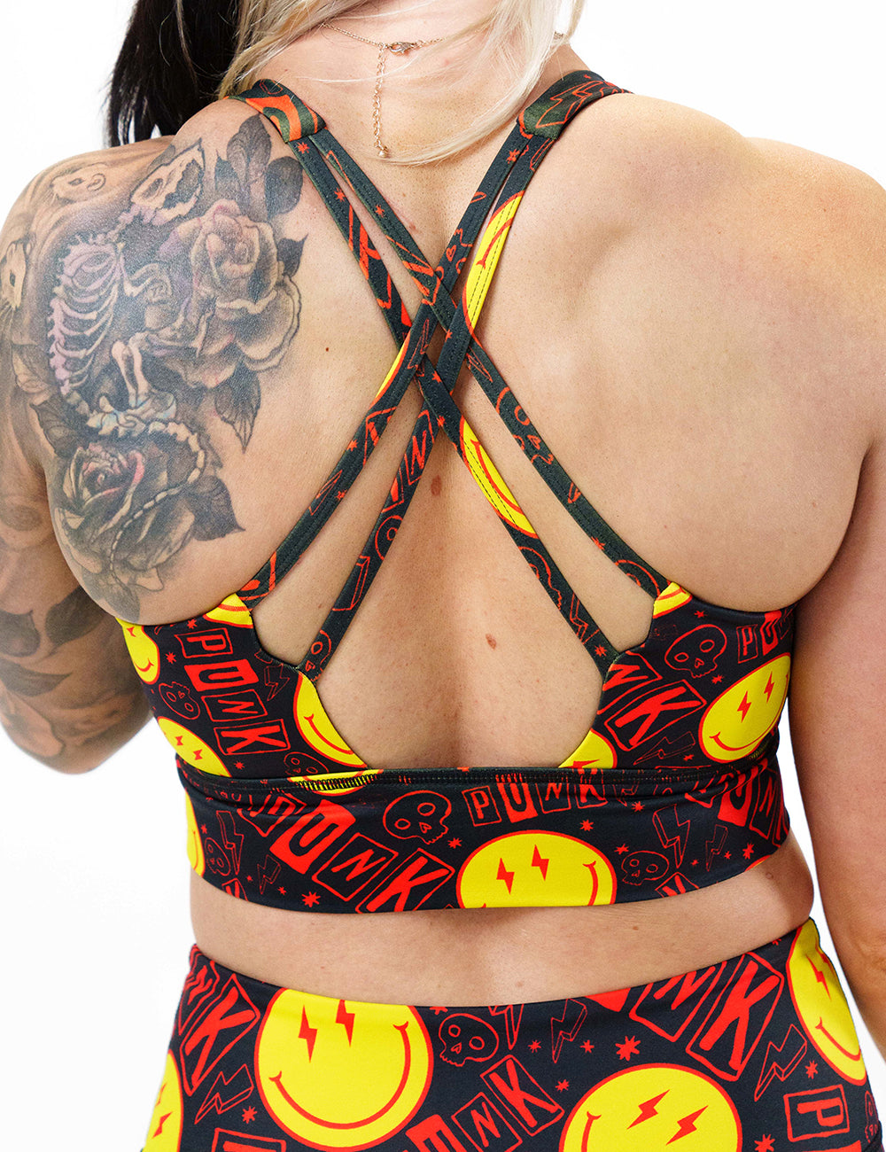 back of smiley face punk rock themed sports bra