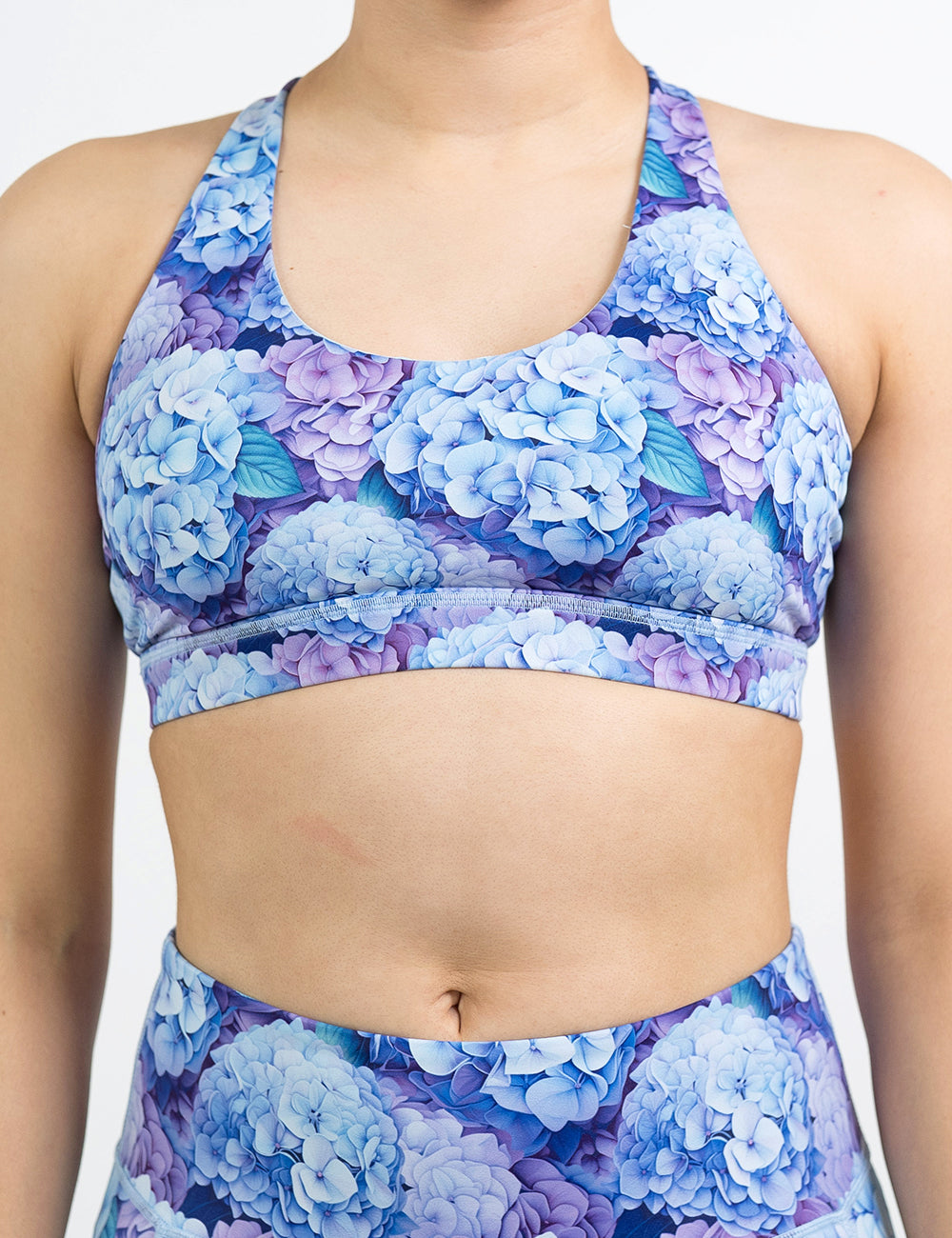 front of the pastel blue and purple hydrangea flower butterfly back bra against a white background