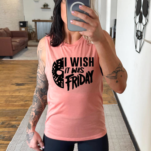 model wearing a peach colored tank top that has a quote saying "I Wish It Was Friday" in black