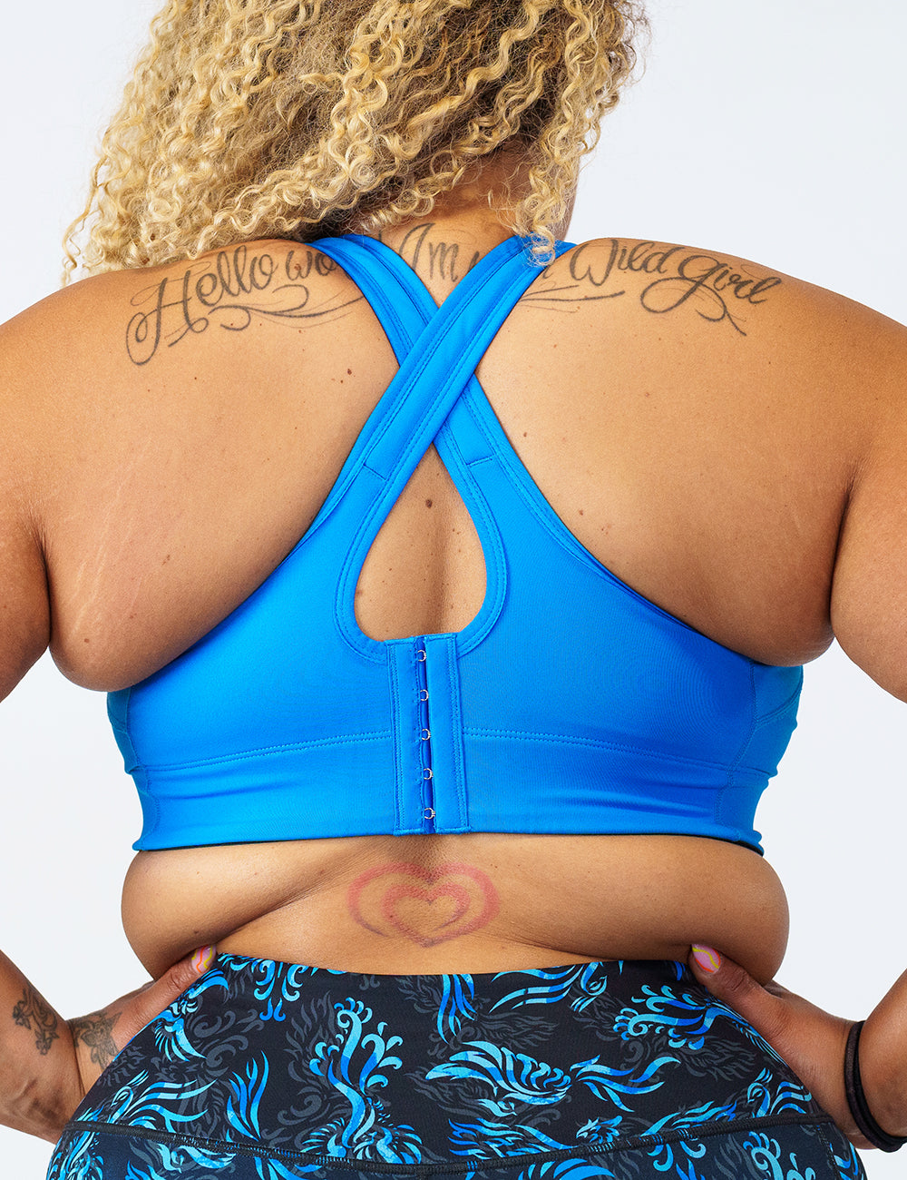 back view of solid blue front zipper sports bra