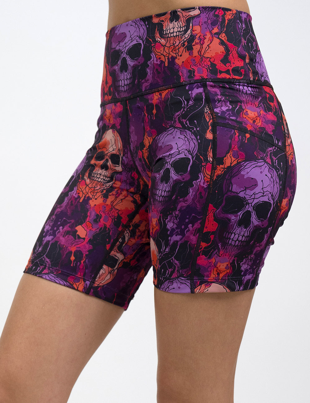 front of the 7 inch purple and orange skull patterned shorts against a white background