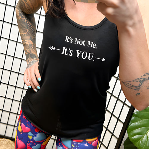 model wearing a black tank top with the saying "It's Not Me It's You" in white