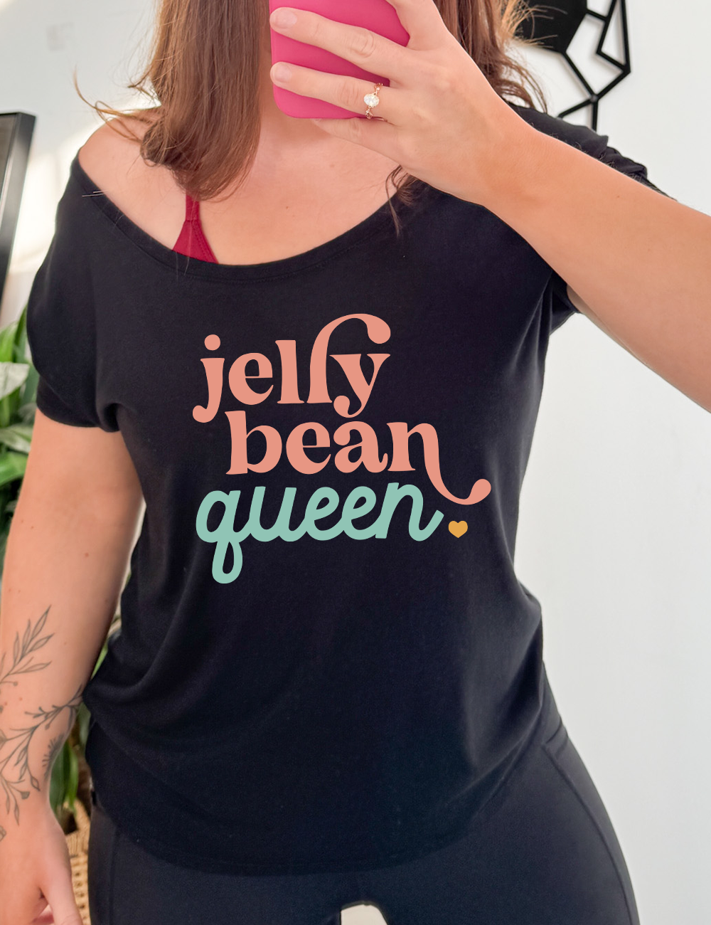 black slouchy tee with the words "jelly bean queen" on it, punctuated with a little heart at the end