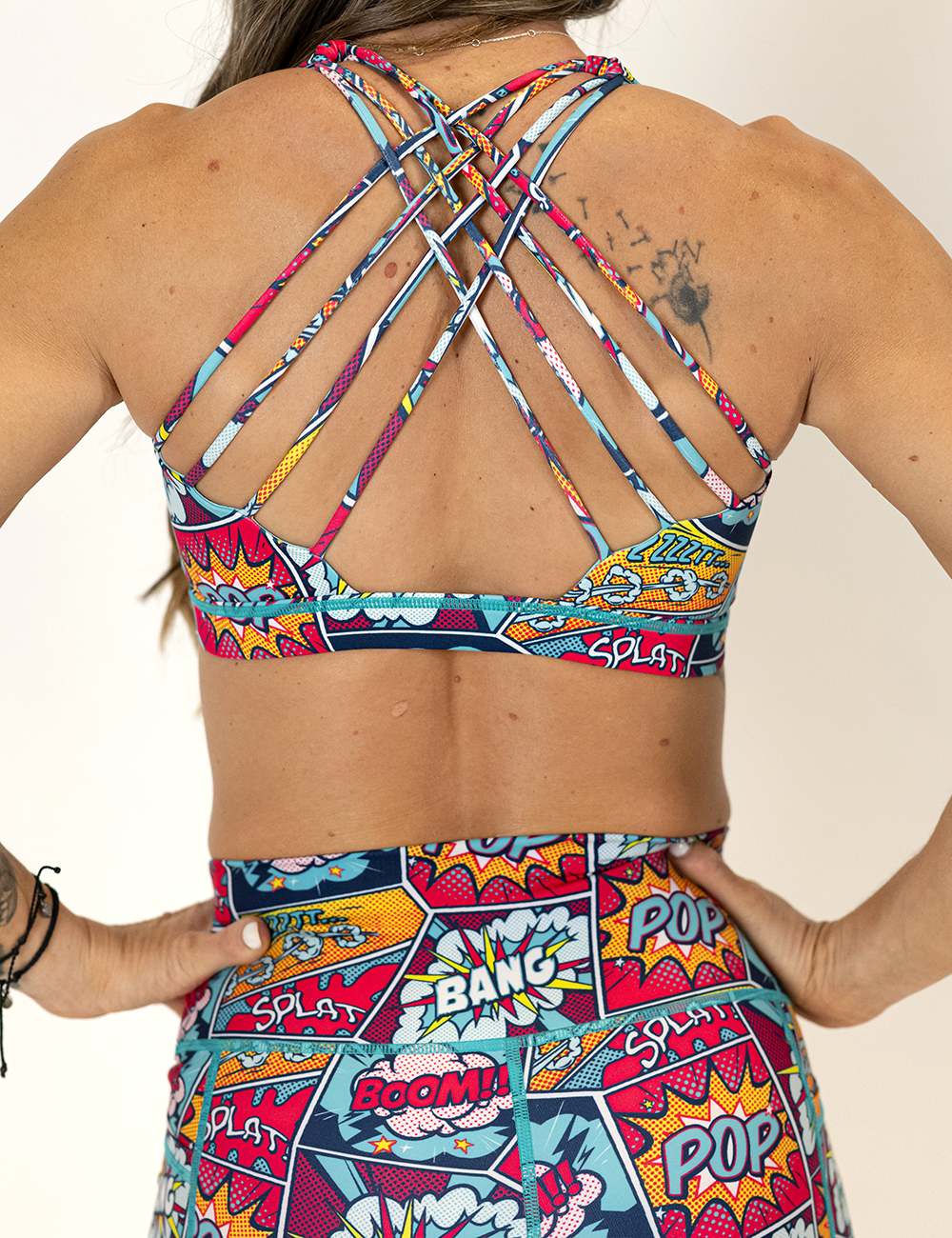 back view of butterfly strap design on comic book inspired print sports bra 