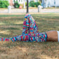 model laying in the grass wearing knockout leggings