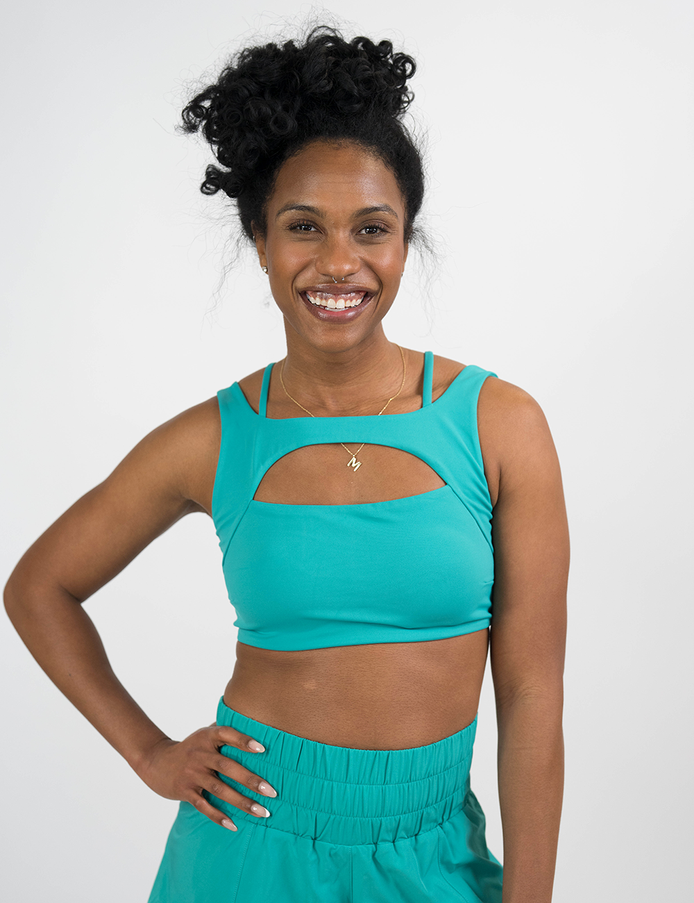 model wearing the solid teal vista bra against a white background