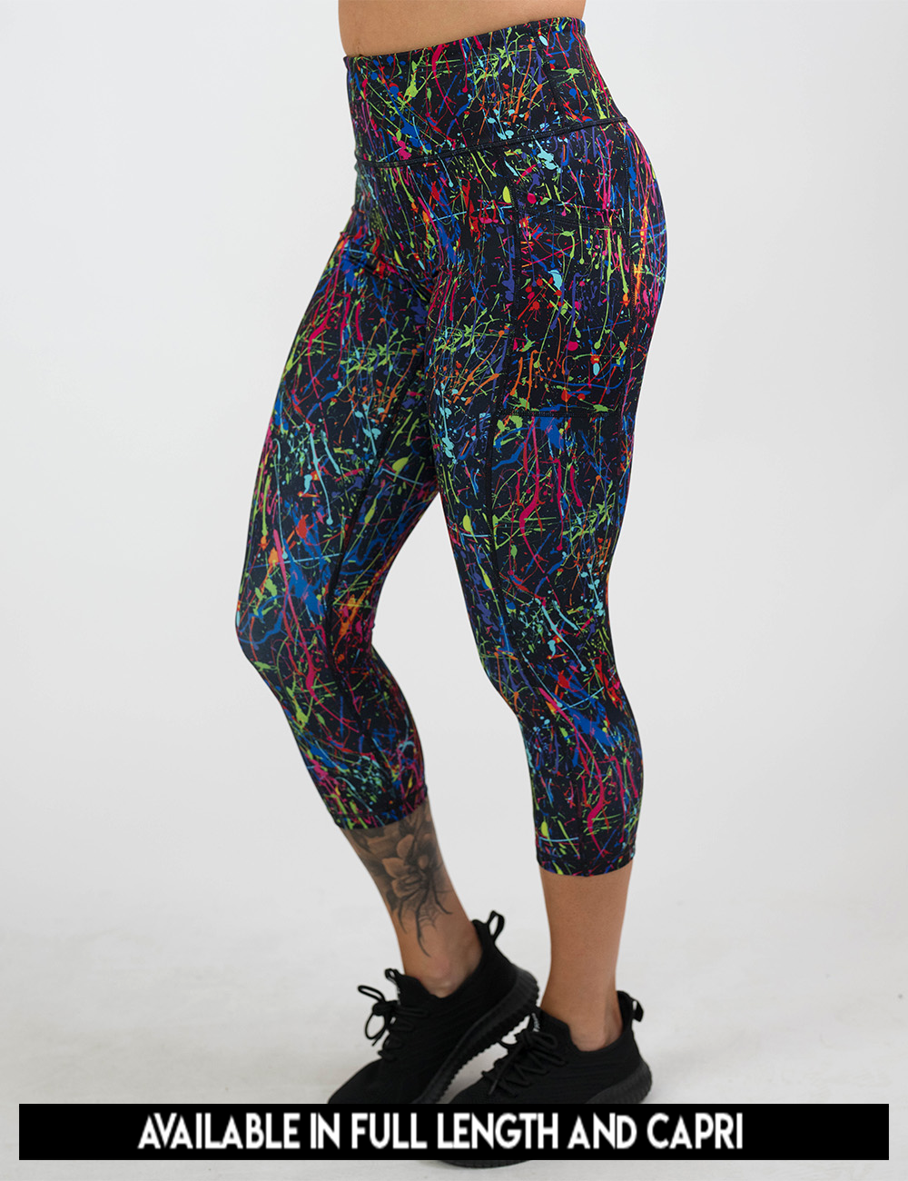 available lengths for the rainbow paint splatter against a black background leggings, lengths include full length and capri
