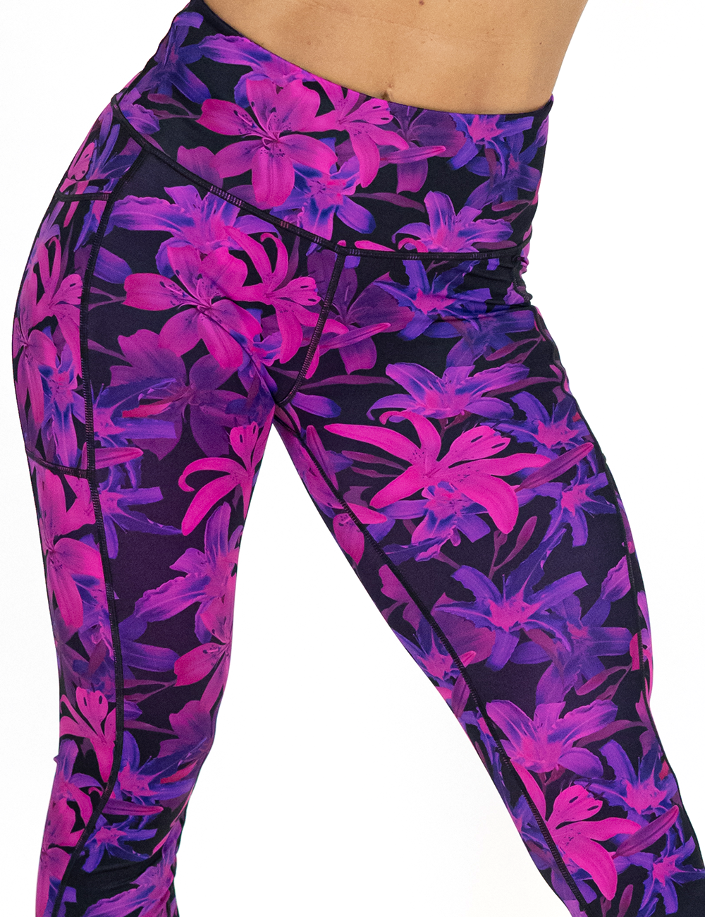 close up of the front of the vibrant purple flowers leggings against a white background